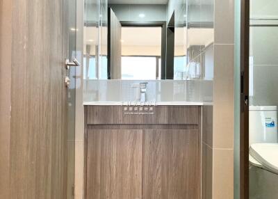 Modern bathroom with wooden vanity and large mirror