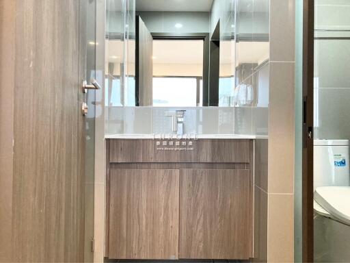 Modern bathroom with wooden vanity and large mirror