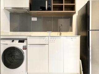 Modern kitchen with appliances and storage.