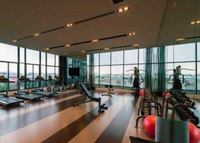 Modern gym with large windows and various equipment