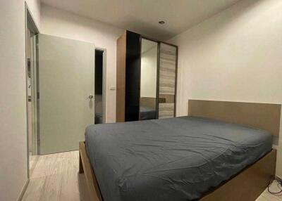A modern bedroom with a double bed and a large wardrobe