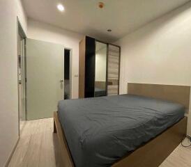 A modern bedroom with a double bed and a large wardrobe