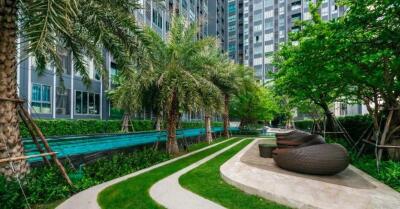 Modern residential building with outdoor pool and lounge area