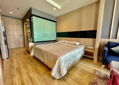 Modern bedroom with wooden flooring, cozy double bed, and contemporary decor