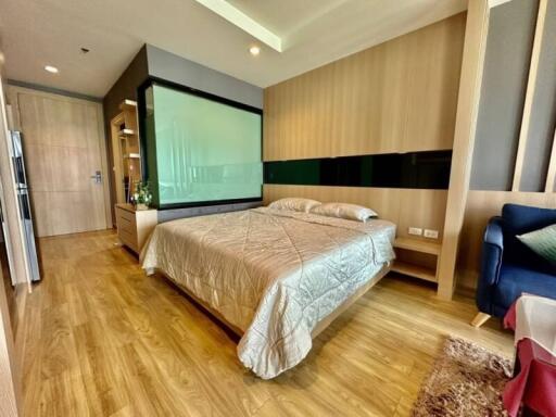 Modern bedroom with wooden flooring, cozy double bed, and contemporary decor