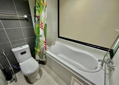 Modern bathroom with white bathtub and toilet