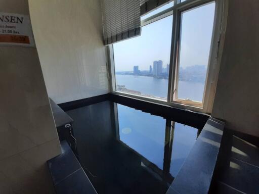 Spacious bathroom with large soaking tub and stunning city view