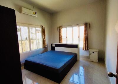 Bright bedroom with bed, window, and air conditioner