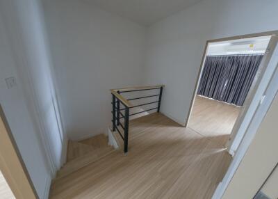 View of a small mezzanine and staircase with wooden flooring