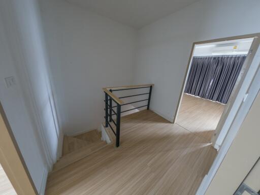 View of a small mezzanine and staircase with wooden flooring