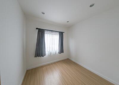 Bedroom with a window and wooden floor