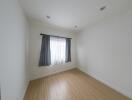 Bedroom with a window and wooden floor