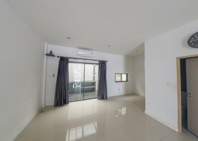 Spacious white living room with large window and sliding glass door