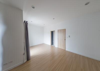 Spacious empty room with wooden floors