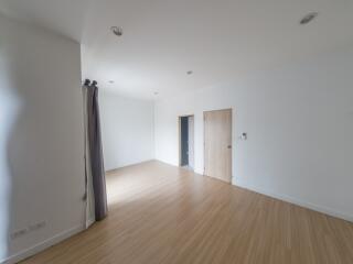 Spacious empty room with wooden floors