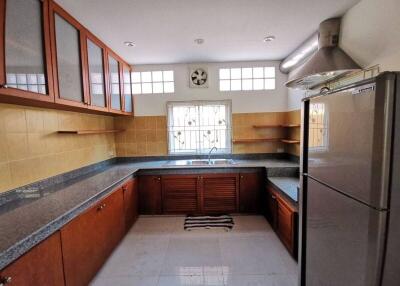 Modern kitchen with wooden cabinets and stainless steel appliances