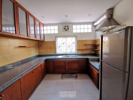 Modern kitchen with wooden cabinets and stainless steel appliances