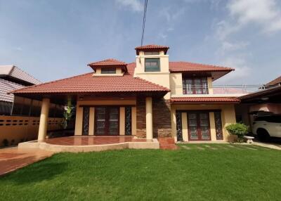 Exterior view of a two-story house with a red tiled roof