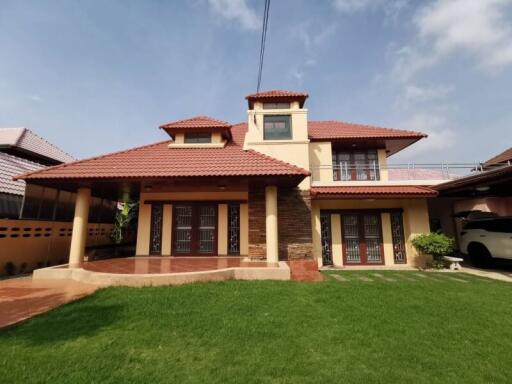 Exterior view of a two-story house with a red tiled roof