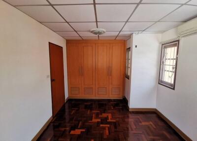 Bedroom with wooden flooring and built-in wardrobe