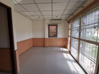 empty room with large windows and ceiling lights