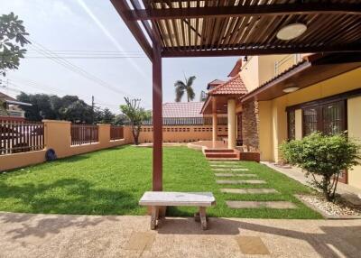 Spacious backyard with patio and greenery