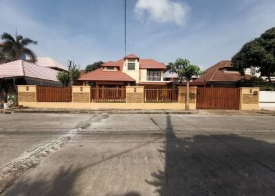 Front view of a residential house with a fenced yard