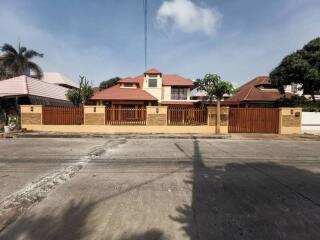 Front view of a residential house with a fenced yard