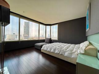 Modern bedroom with large windows and city view