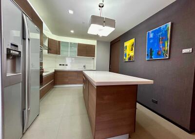 Modern kitchen with an island, stainless steel appliances, and contemporary decor