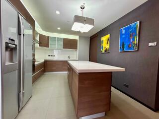 Modern kitchen with an island, stainless steel appliances, and contemporary decor