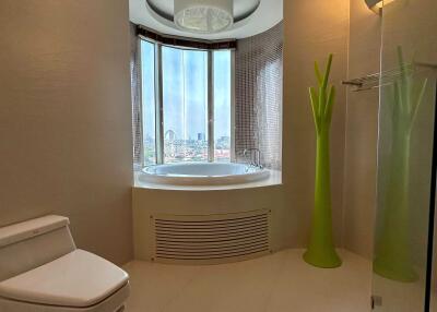 Modern bathroom with a circular bathtub and a city view