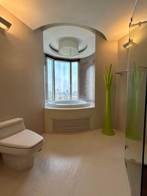 Modern bathroom with a circular bathtub and a city view