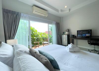 Bright and spacious bedroom with a balcony view
