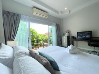 Bright and spacious bedroom with a balcony view