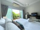 Bright and spacious bedroom with a balcony view