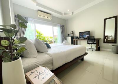 Modern bedroom with a desk and large window