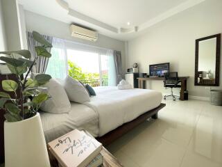 Modern bedroom with a desk and large window