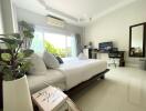 Modern bedroom with a desk and large window