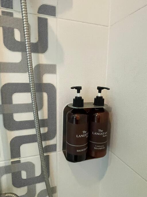 Shower area with wall-mounted shampoo and shower gel dispensers