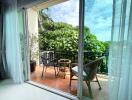 Balcony with outdoor seating area and greenery view