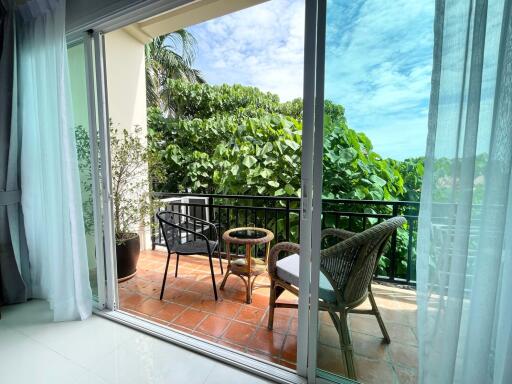 Balcony with outdoor seating area and greenery view