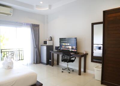 Spacious bedroom with a work desk and modern amenities