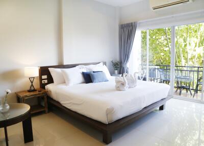 Spacious bedroom with large bed and balcony