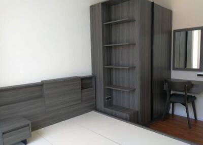 Modern bedroom with built-in shelving and desk