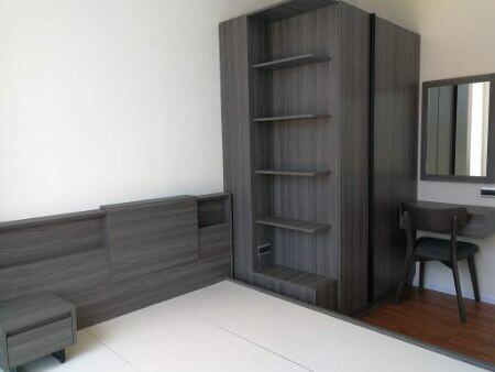 Modern bedroom with built-in shelving and desk