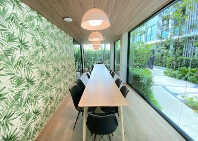 Bright, modern communal room with long table and chairs