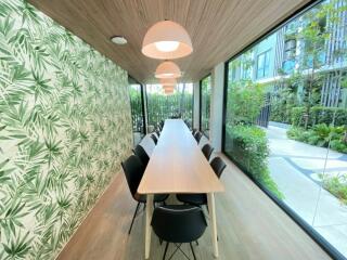 Bright, modern communal room with long table and chairs