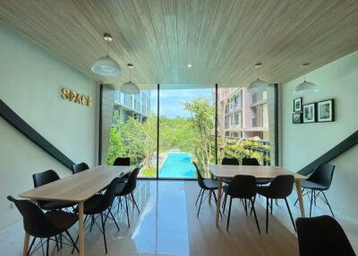 Spacious common area with large windows and pool view