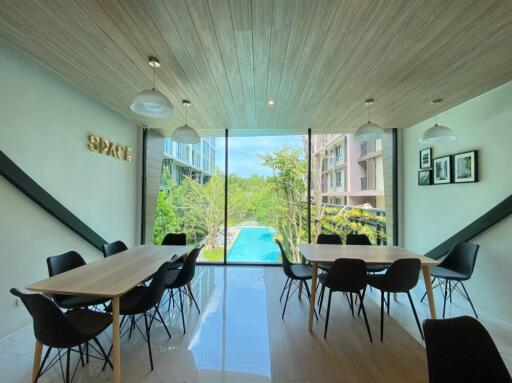 Spacious common area with large windows and pool view